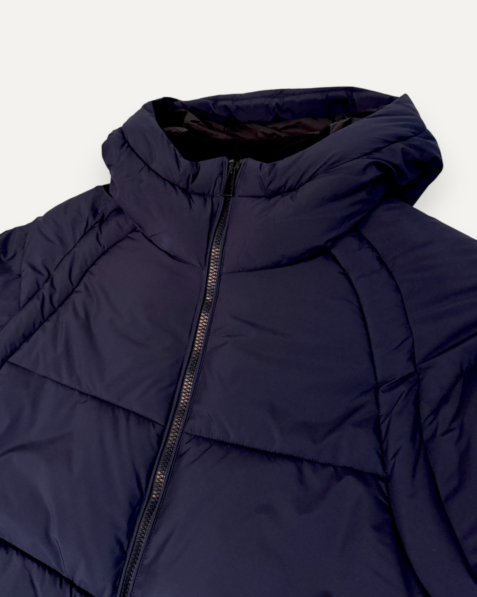 Navy blue puffer jacket on a white background